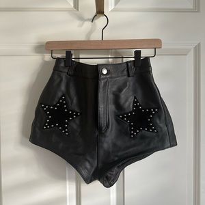 Understated Leather black leather star studded shorts, size x small.